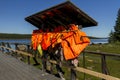 Many orange life vests hanging near the boat station Royalty Free Stock Photo