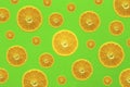 Many orange slices, half sliced oranges of different sizes against a strong colored background in green Royalty Free Stock Photo