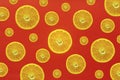 Many orange slices, half sliced oranges of different sizes against a strong colored background in red Royalty Free Stock Photo