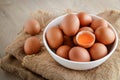 Many organic chicken eggs are placed in a white bowl.