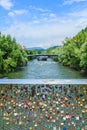 Many padlocks on bridge with view of the artificial island on the Mur river in Graz Royalty Free Stock Photo