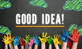 Many painted kids hands with smileys and the message `Good Idea!` Royalty Free Stock Photo