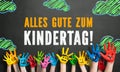 Many painted kids hands with smileys and the message `Happy Childrens Day`