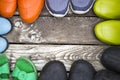 Many pairs of summer shoes: Rubber boots, slippers, galoshes on a vintage wooden floor, Royalty Free Stock Photo