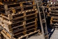 Many pallets stacked in stock, warehouse pallets. Old wooden material