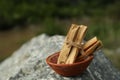 Many palo santo sticks on stone surface outdoors, closeup. Space for text Royalty Free Stock Photo