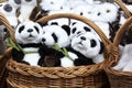 many panda soft toys in a wicker basket.