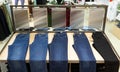 Many pants and jeans are hung in the department store