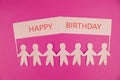 Many paper People Holding a Colorful Happy Birthday sign Royalty Free Stock Photo