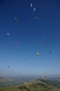 Many para-gliders over a green landscape Royalty Free Stock Photo