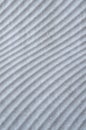 Many parallel embossed white curves on slab close