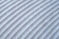 Many parallel embossed white curves on slab close