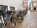 Many parked bicycles near building on city street Royalty Free Stock Photo