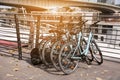 Many parked bikes near modern bridge outdoors