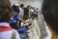 Many passengers waiting suitcase or luggage with circulating conveyor belt in the international airport