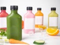 Many pastel color drink in plastic bottle container with empty logo label. mixed many vegetables and fruits smoothie juice on stud