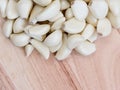 many white cloves of garlic on a wooden cutting board. Copy space for text Royalty Free Stock Photo