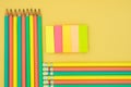 Many pencils and paper with glue, on yellow background Royalty Free Stock Photo