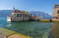 Tourists on a boat in Malcesine Lake Garda Alps Italy