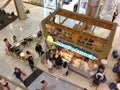 Many people buying some food from Auntie Anne`s shop