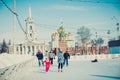 Many people in the city skating rink on the central square in the background of the Tula Kremlin.