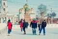 Many people in the city skating rink on the central square in the background of the Tula Kremlin.