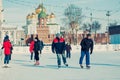 Many people in the city skating rink on the central square in the background of the Tula Kremlin. Winter in Russia.