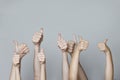 Many people congratulate a winner and holding their thumbs up. Human hands with thumb up Royalty Free Stock Photo