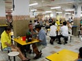 Many people eat and drink in a typical Singapore food court or Hawker Royalty Free Stock Photo