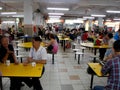 Many people eat and talk quietly in a typical Singapore food court or Hawker Royalty Free Stock Photo