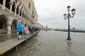 many people on the footbridge with plastic gaiters in Venice in