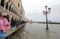 many people on the footbridge with plastic gaiters in Venice in