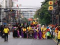 Many people in front of the float carrying a Buddha in a Festival of the Clans of the Chinese community of Bangkok