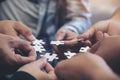 Many people hands holding a jigsaw puzzle in circle together Royalty Free Stock Photo