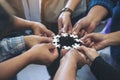 Many people hands holding a jigsaw puzzle in circle together Royalty Free Stock Photo