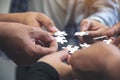 Many people hands holding a jigsaw puzzle in circle together Royalty Free Stock Photo