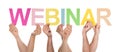 Many People Holding The Colorful Word Webinar