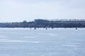 Many people on ice, winter fishing, frozen river in winter, ice fishing