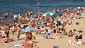 Crowded summer beach, people sunbathe in the sun