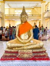 Many people pray respect Golden Buddha statue inside