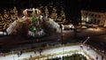 Many people skating on ice skating rink in open air decorated New Year Christmas