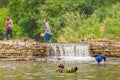 Many people swimming at the small weir irrigate