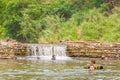 Many people swimming at the small weir irrigate