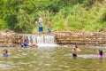 Many people swimming at the small weir irrigate