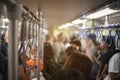 Many people are traveling by electric train during rush hour.This image is soft Focus