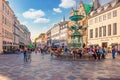 Many people walk near Stork Fountain on Amager Square Amagertorv at the StrÃÂ¸get pedestrian zone. Copenhagen, Denmark