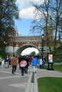 Many people walk under Figured Bridge. Architecture of Tsaritsyno park in Moscow. Color photo