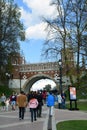 Many people walk under Figured Bridge. Architecture of Tsaritsyno park in Moscow. Color photo