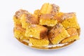 Many pieces of Cornbread served on a plate isolated on an empty white background