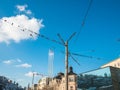 Many pigeons bird on an electric wires. Doves sitting on a power lines over blue sky